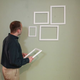 Illustration for article titled Man Not Sure Why Girlfriend Having Him Hang Cluster Of Empty Picture Frames But Willing To Go With It